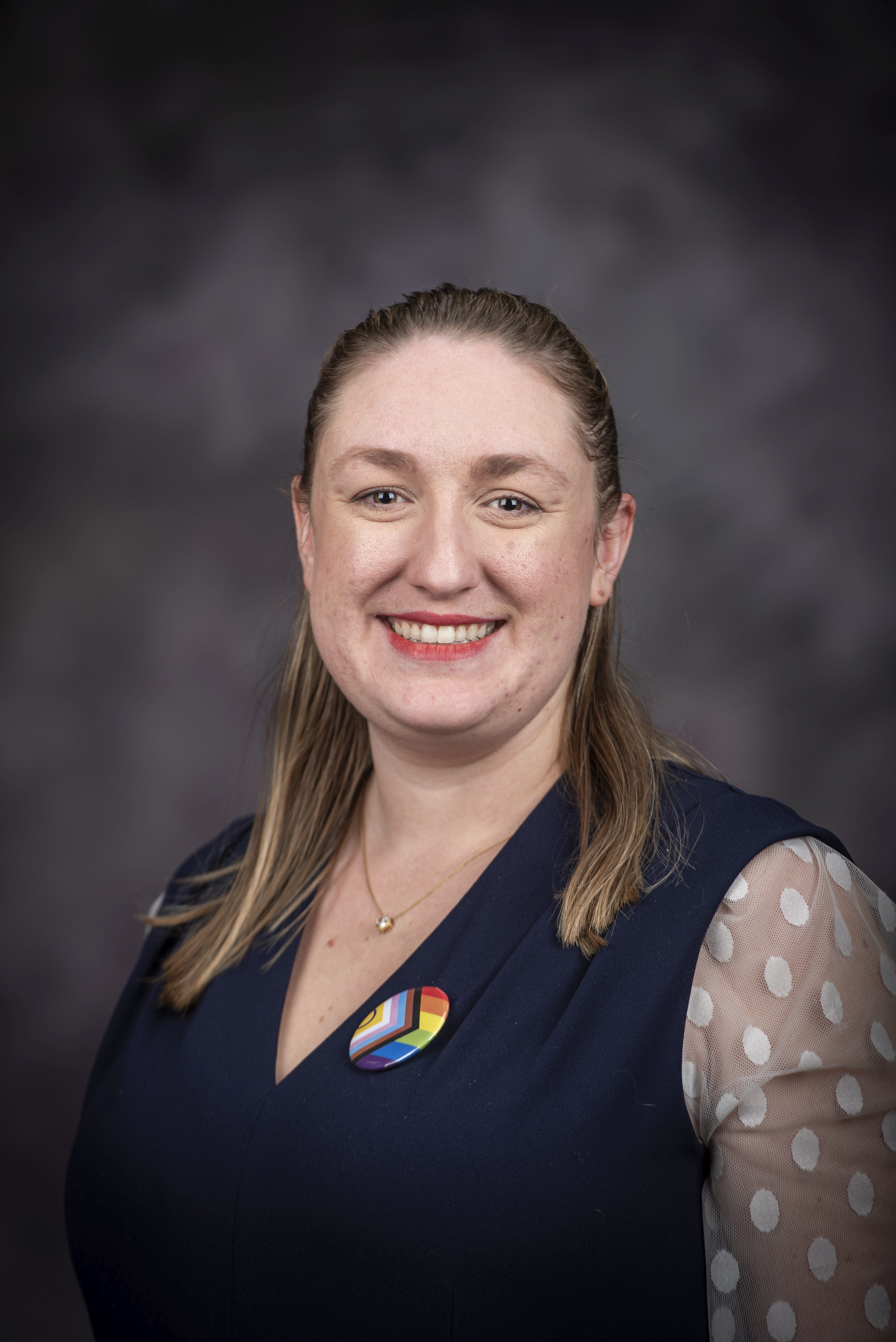 woman in navy top smiling Parker Poulos